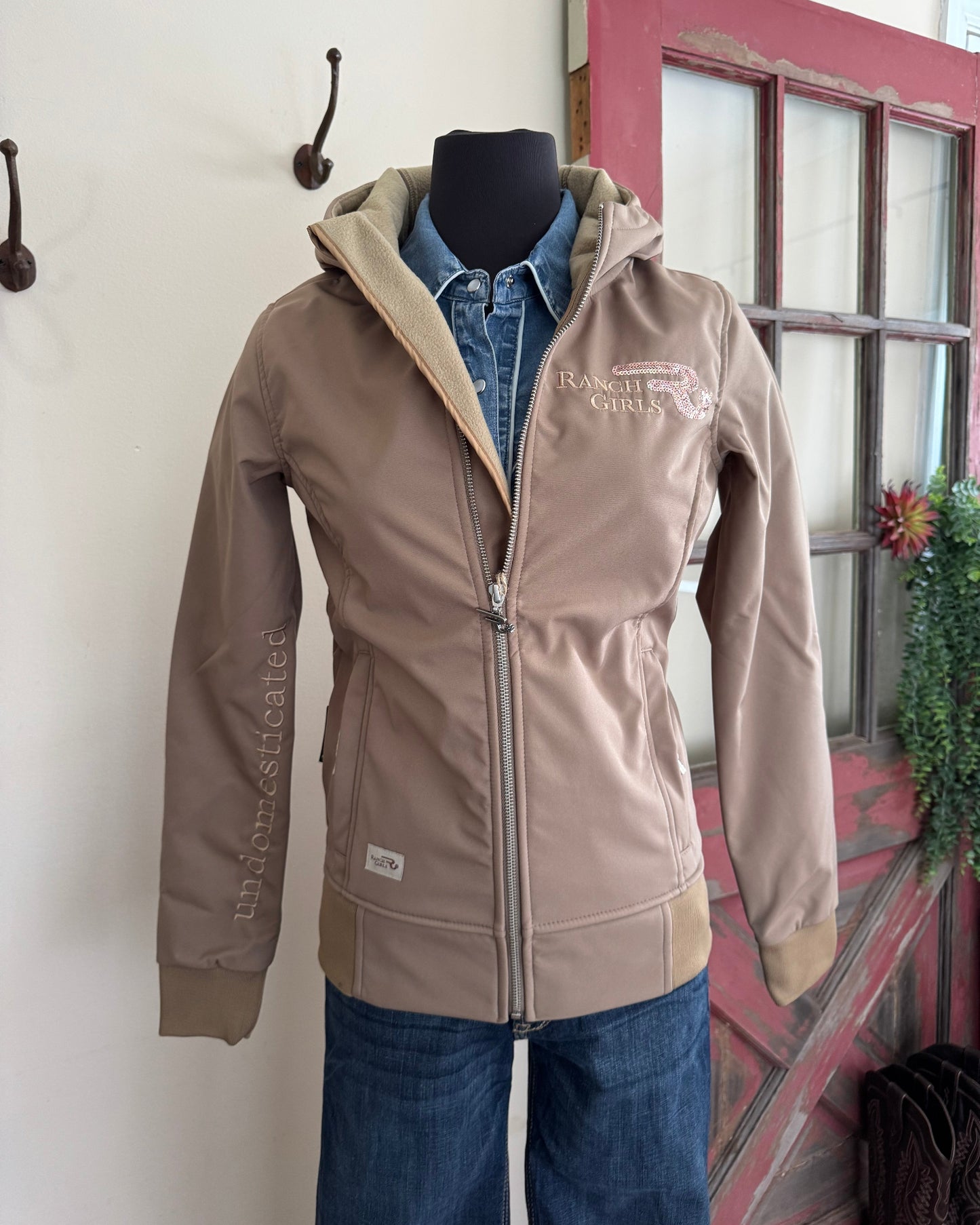 Brown jacket with visible branding on a white surface