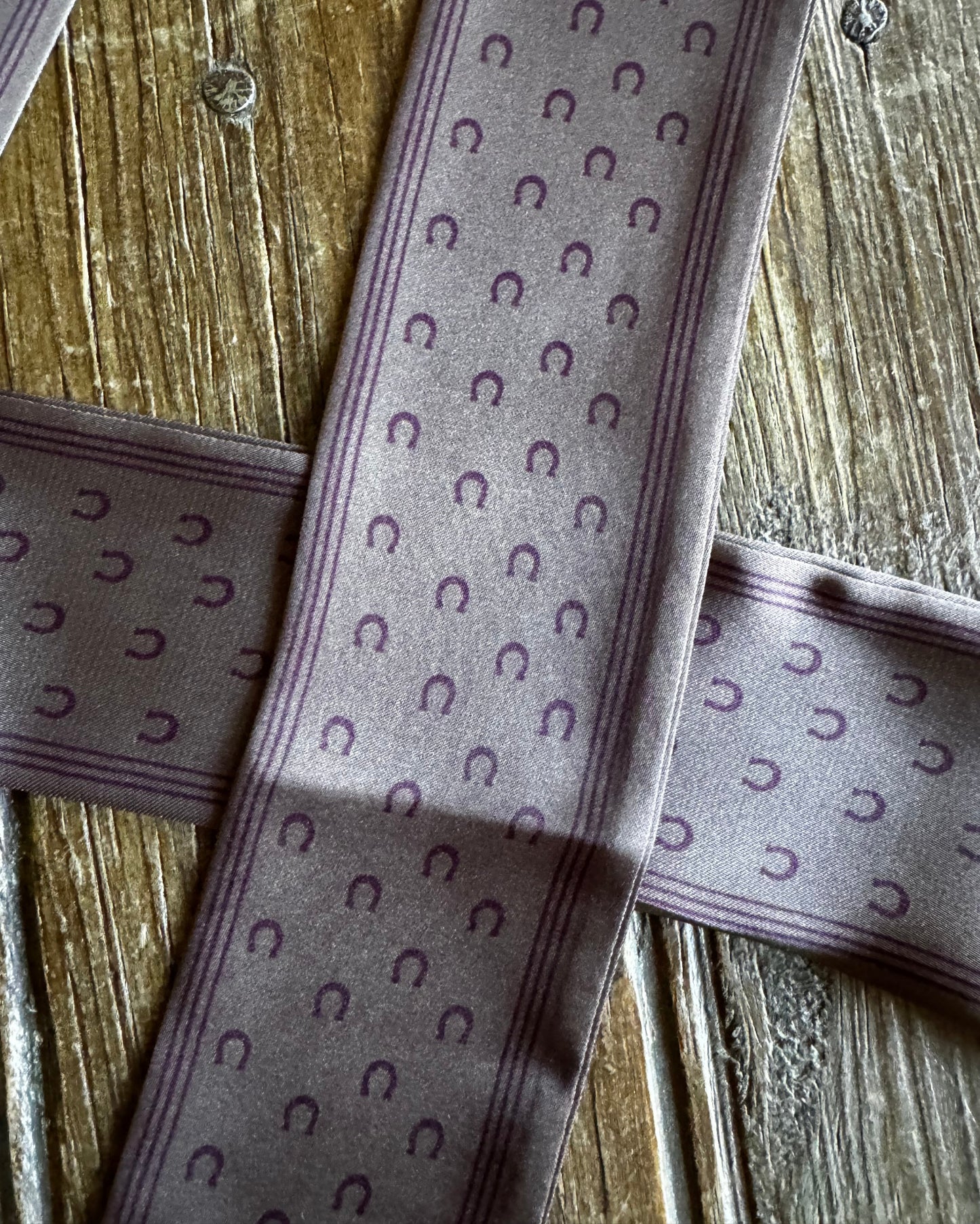 Close-up of patterned ribbons on a wooden surface