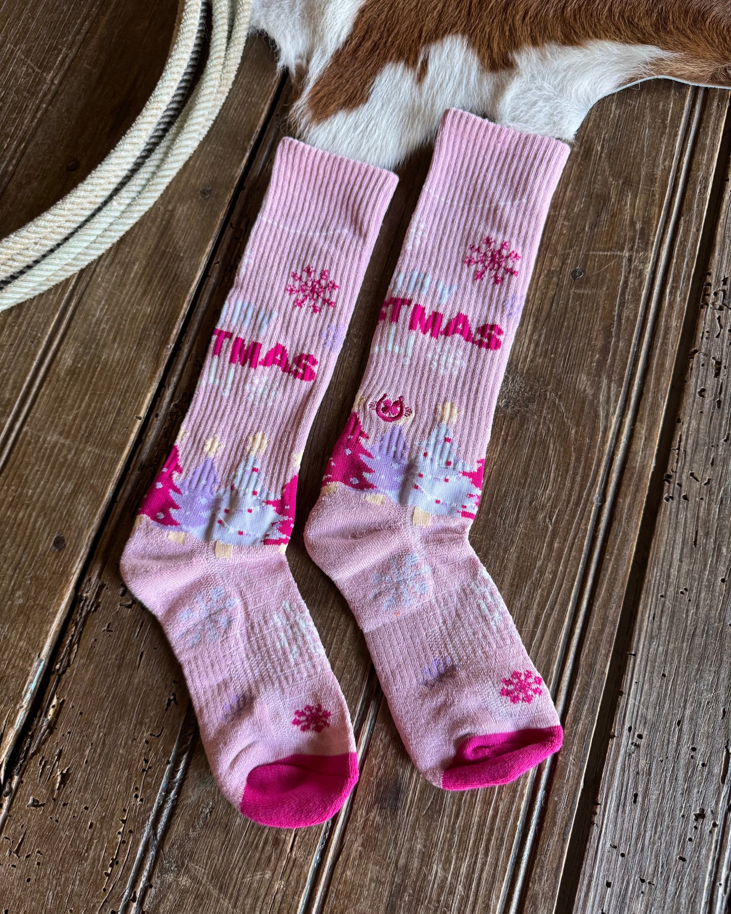 Pink socks with floral patterns on a wooden floor