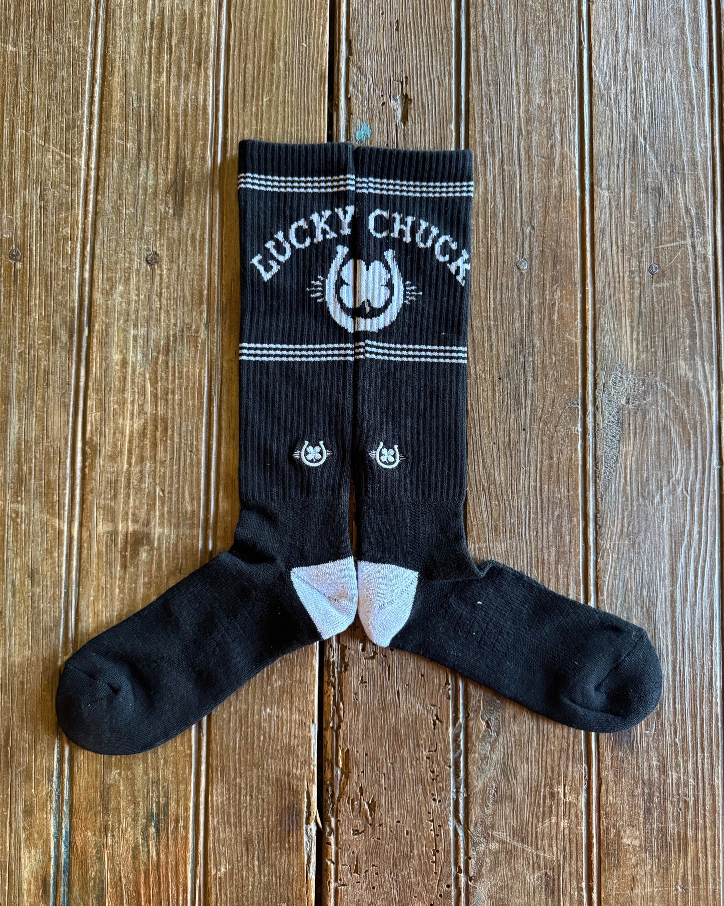 Retro Lucky Chuck Performance Socks showing design on rustic wood background