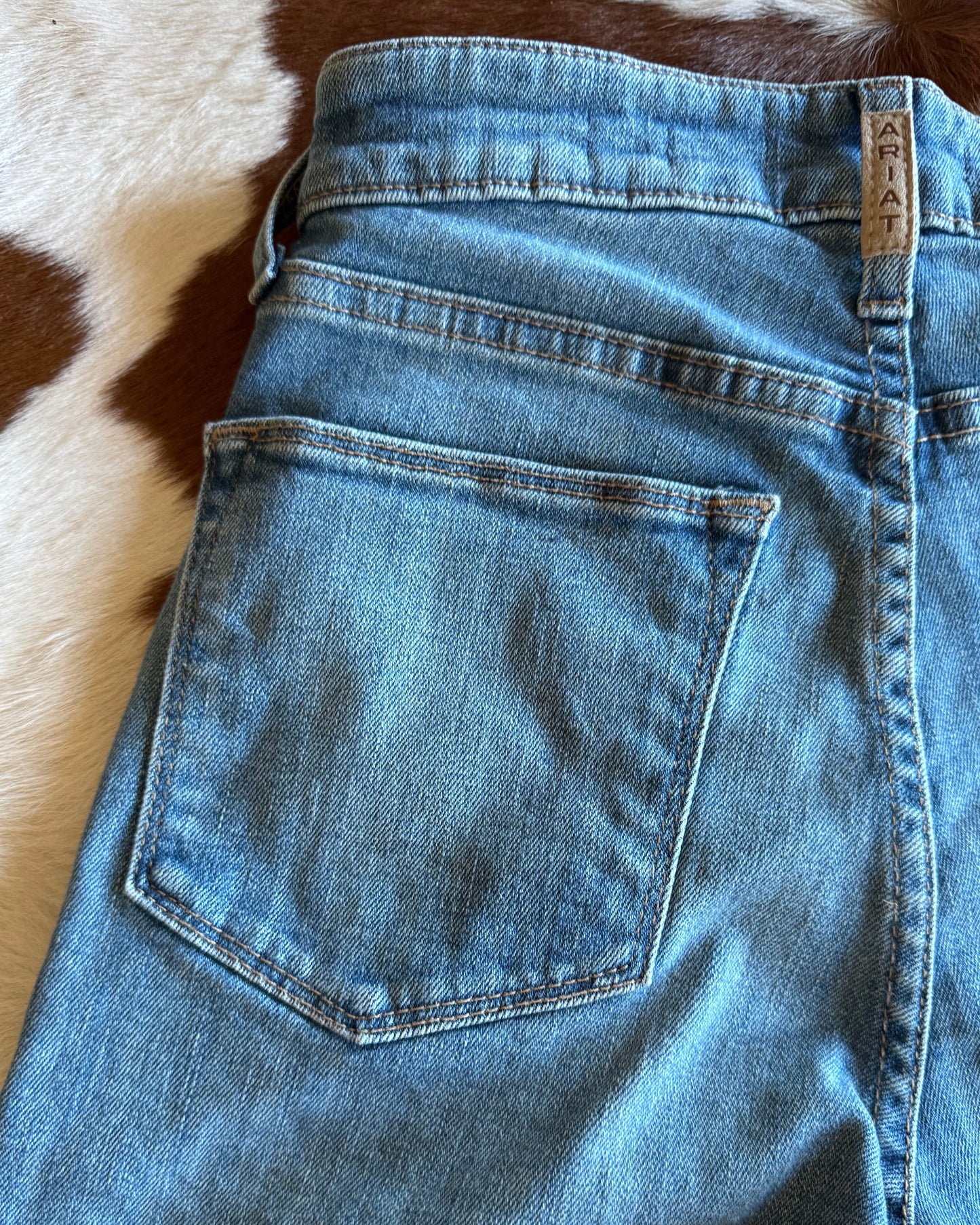 Plain back pocket of jeans on cowhide background