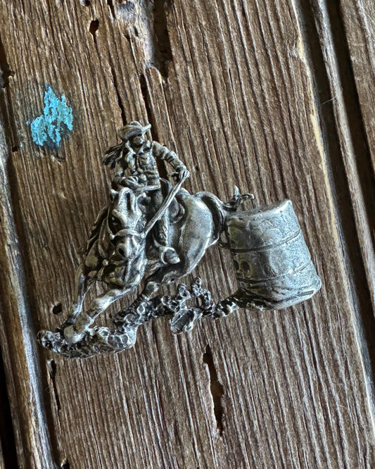 barrel racer pin on wooden background