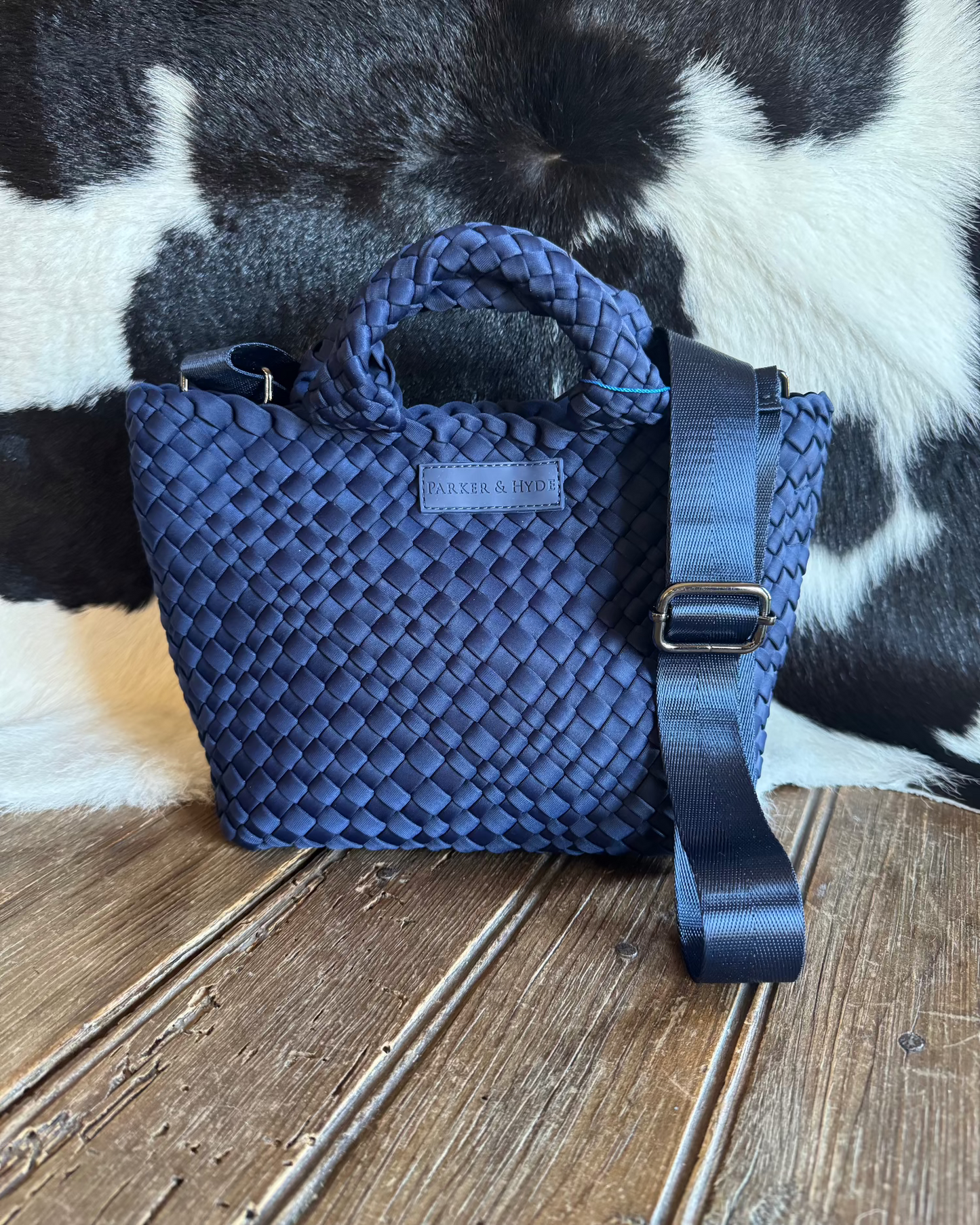 Woven handbag with cowhide background