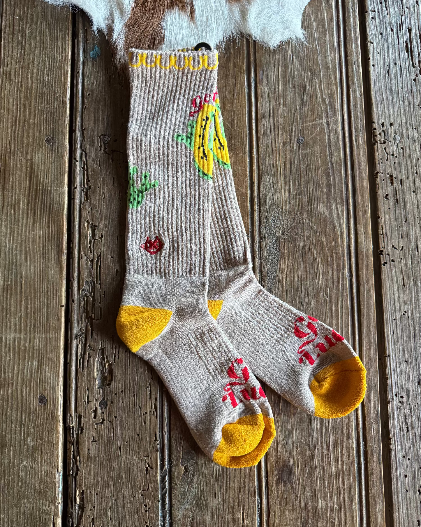 Sock with banana design on a wooden surface