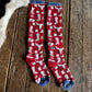 Red socks with white patterns on a wooden surface