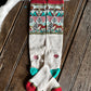 Colorful patterned socks on a wooden surface with animal fur