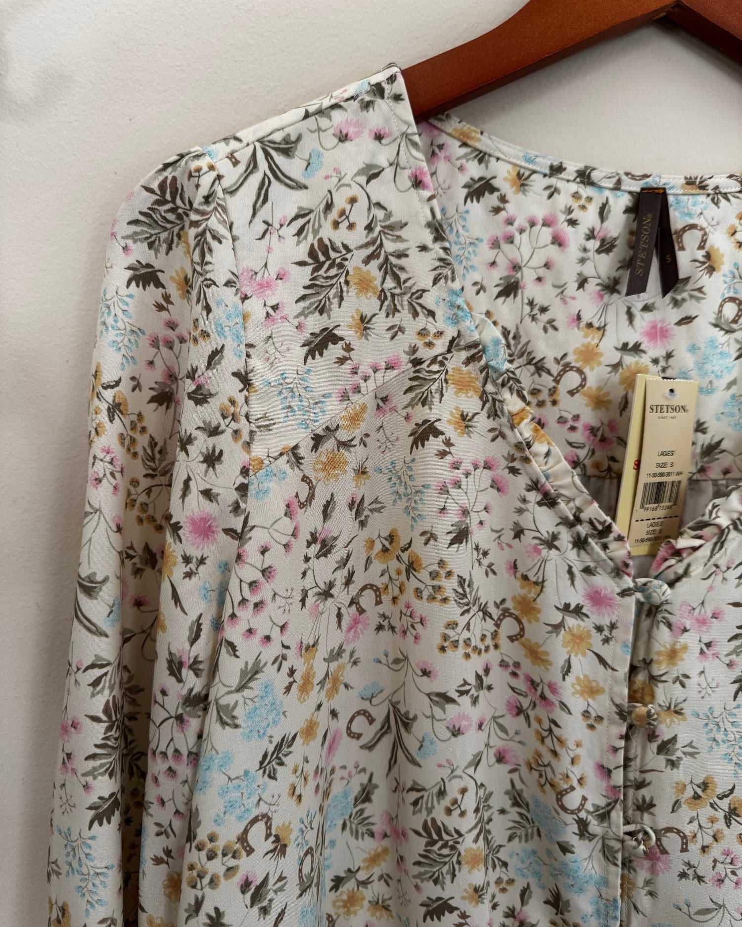 Floral-patterned fabric with a tag on a white surface