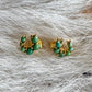 Turquoise and gold horseshoe earrings on a cowhide 