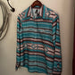 Striped shirt with geometric pattern hanging on a hook against a white wall