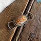 Fawn jasper twilly slide on a rustic wooden background 