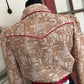 Brown patterned garment on a rack with visible tags.