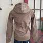 Brown jacket with a logo on the back, on a mannequin against a white wall.