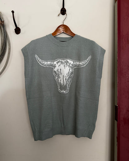 Green sweater with a white graphic on a white surface