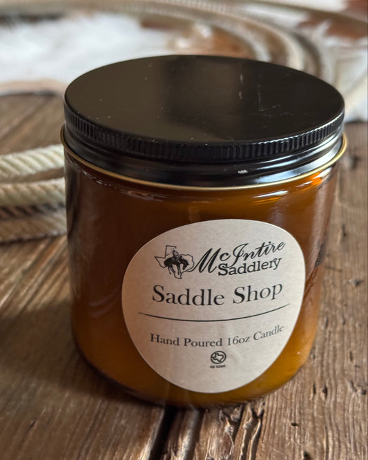 Jar of saddle shop product with a label on a wooden surface