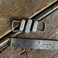 Twilly slide with grey and turquoise stones on a wooden surface with a ruler for scale