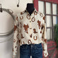 Mannequin wearing a white shirt with brown cowboy pattern and blue jeans against a neutral background.