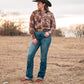 model standing in field wearing a fashionable modern western outfit