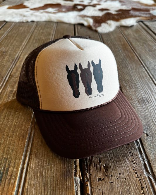 Trucker hat with horse design on a wooden surface