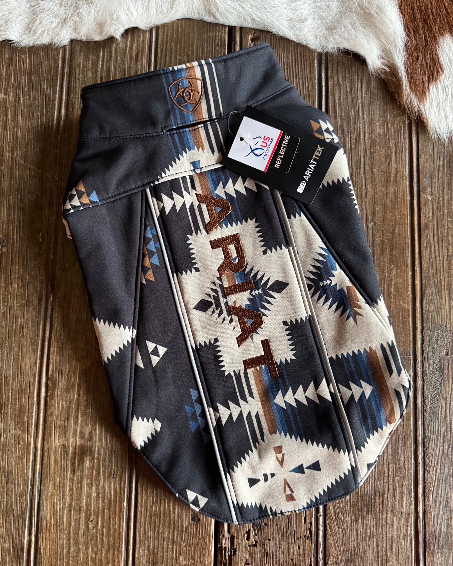 Ariat dog coat with a pattern on a wooden surface