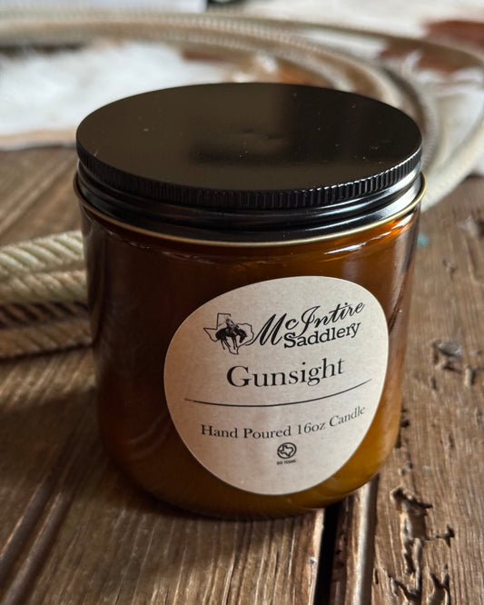 Jar of candle with a label on a textured surface