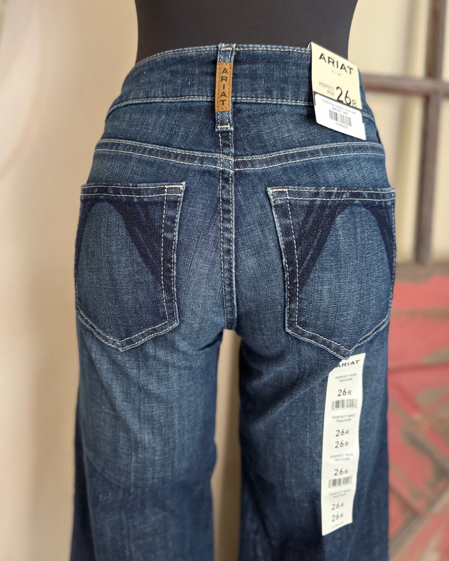 Blue jeans on a mannequin with Ariat label