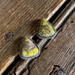 triangle stud earrings on a wooden surface