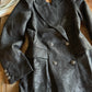 Dark jacket with paisley pattern on a wooden surface