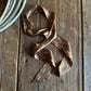 Brown ribbon scarf on a wooden surface