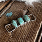 Turquoise stone necklace on a wooden surface with white fur