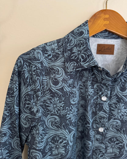 Blue patterned shirt on a hanger against a beige background