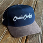 Blue and gray cap with 'Classic Cowboy' text on a wooden surface