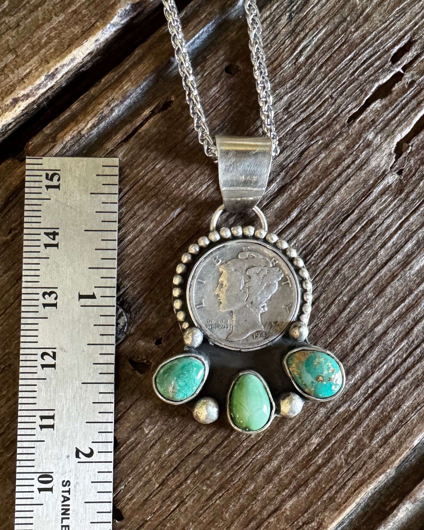 dime necklace with turquoise stones on wooden background with ruler for size 