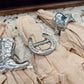 Silver buckles on beige fabric with a blurred background