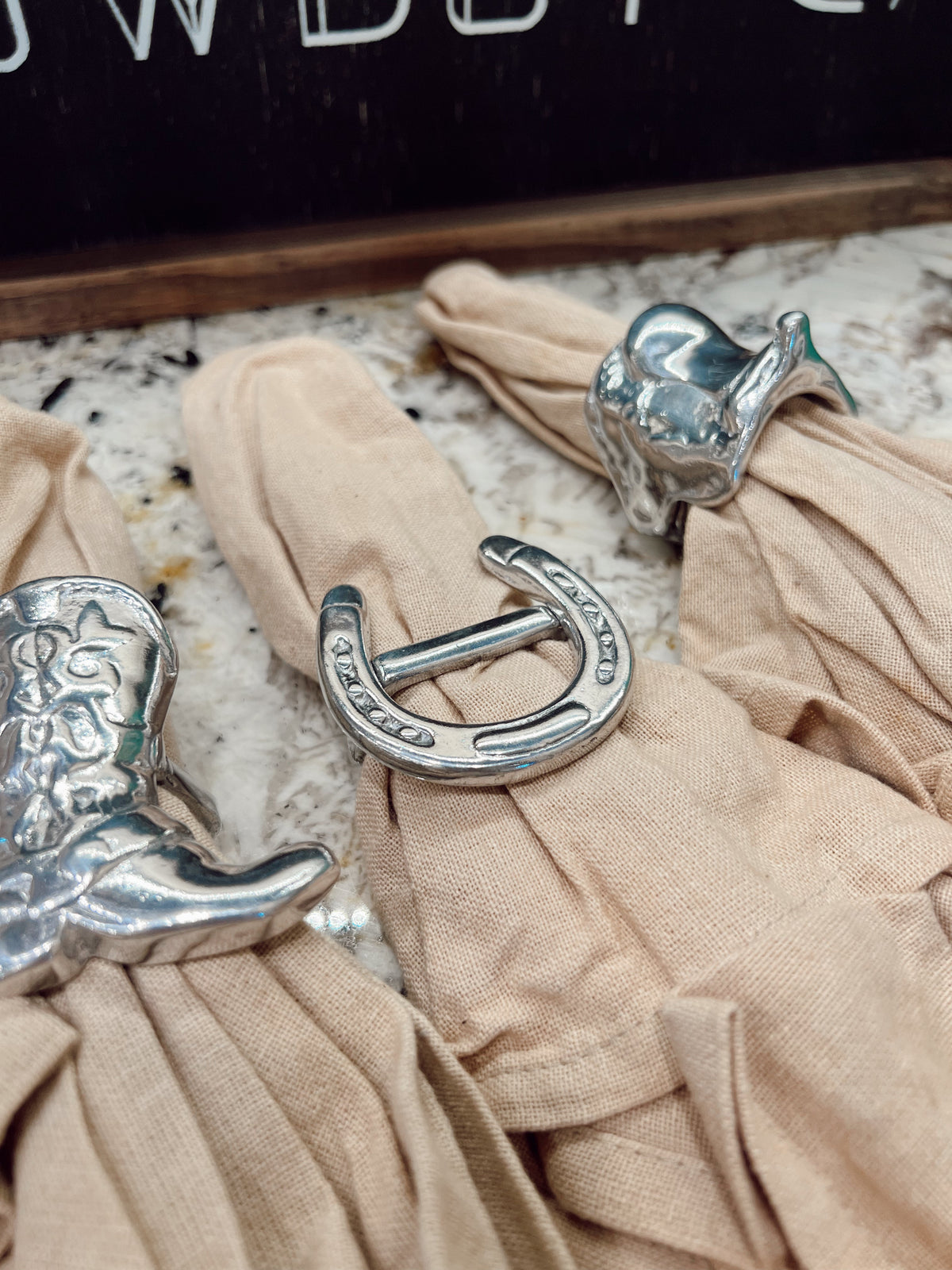 Silver buckles on beige fabric with a blurred background