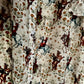 Close-up of a shirt with a pattern of horses and riders on a white background
