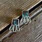 Pair of earrings on a wooden surface