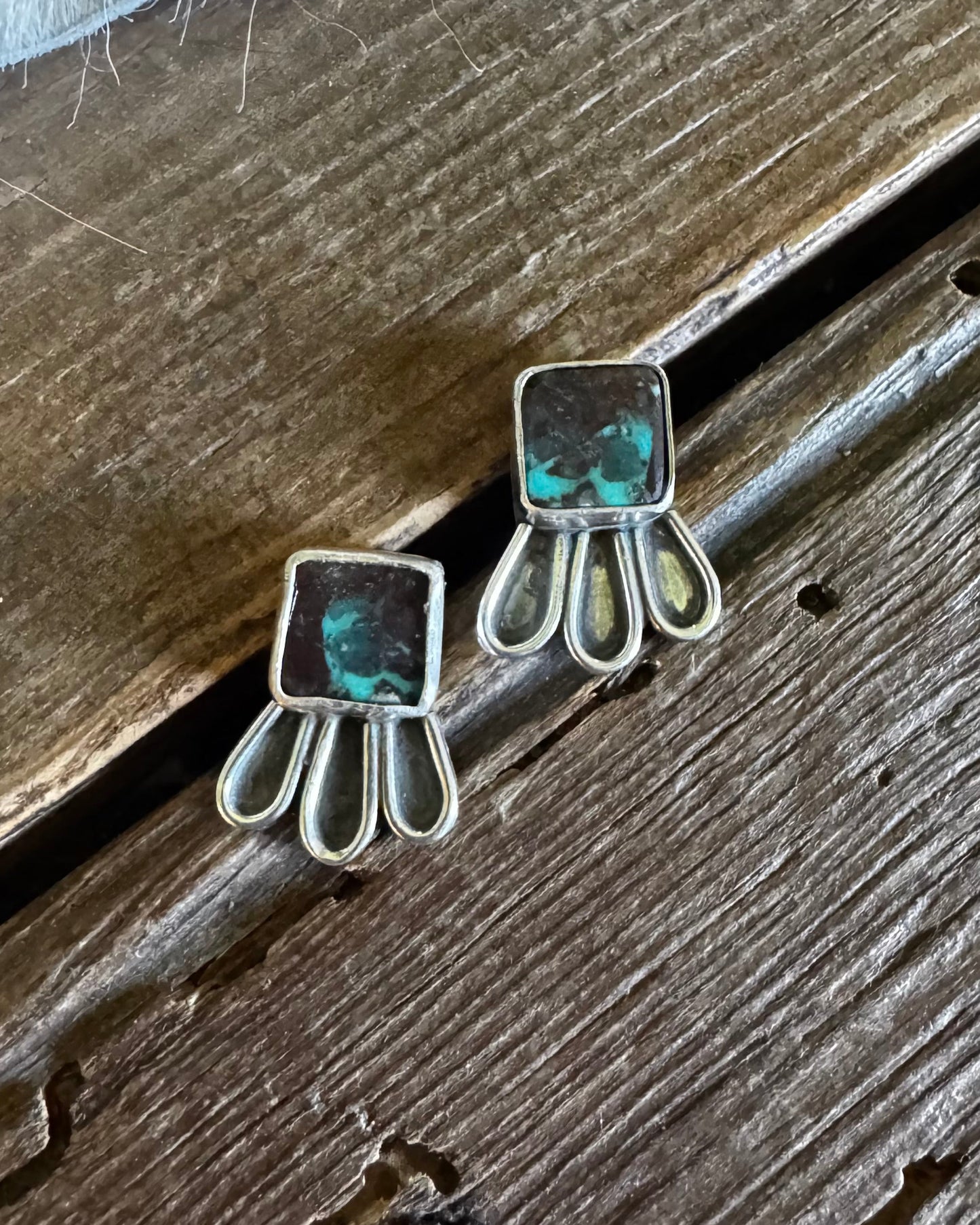 Pair of earrings on a wooden surface