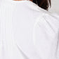 Close-up of a person wearing a white shirt with a blurred background