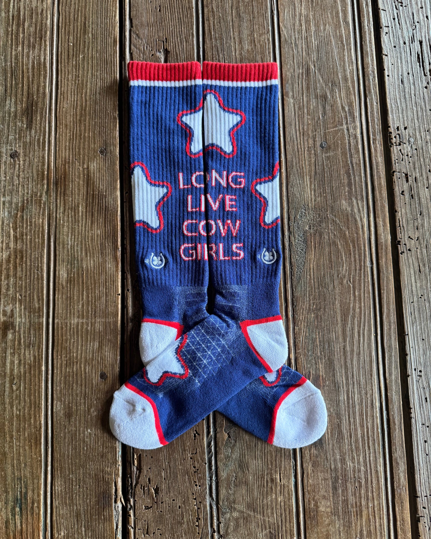 Long Live Cowgirls Performance Socks (Red/Blue) on rustic wood background 