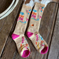Two socks with colorful designs on a wooden surface