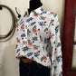 Floral-patterned bag on a white surface with a blurred background