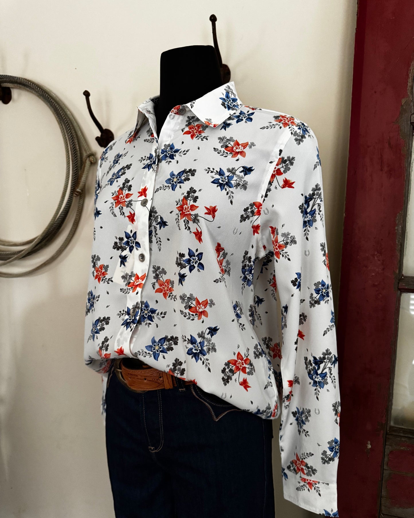 Floral-patterned bag on a white surface with a blurred background