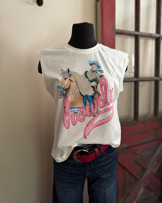 White sleeveless shirt with a graphic design of a cowboy and horse on a mannequin against a neutral wall.