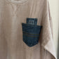 Beige corduroy shirt with denim pocket on a hanger