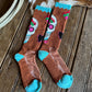 Pair of brown socks with colorful designs on a wooden surface