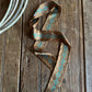 Patterned ribbon scarf on a wooden surface