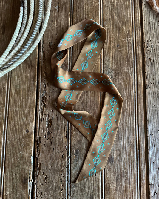 Patterned ribbon scarf on a wooden surface