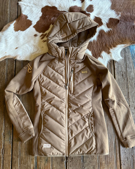 Beige quilted jacket on a wooden surface with cowhide rug