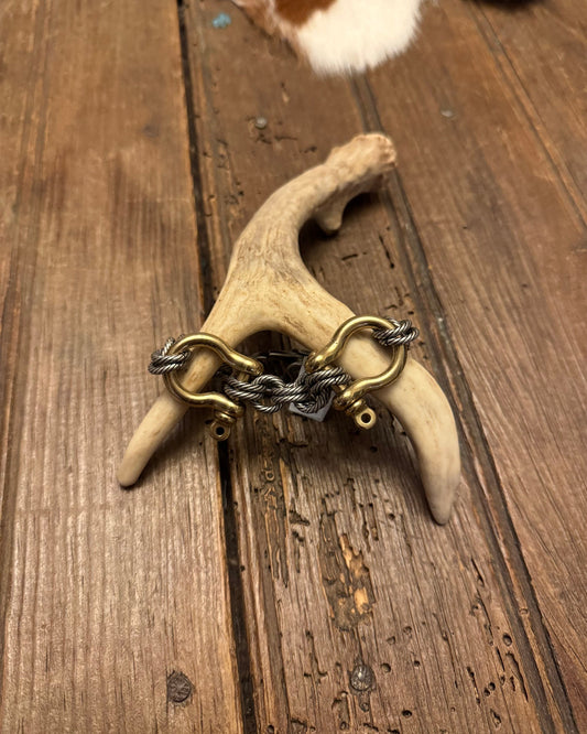 Decorative item with a chain on a deer antler on a wooden surface