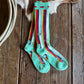 Pair of striped socks on a wooden surface with a cowhide